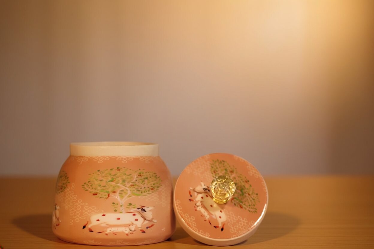 Pichwai Resting Cow Under the Sacred Tree Metal Jar – Blush Peach & Gold | Hand-Painted Decorative Storage Jar with Diamond Crystal Knob Lid
